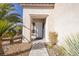 Charming home entrance framed by lush landscaping and a shaded walkway, offering curb appeal at 9678 Swaying Elms Ct, Las Vegas, NV 89147