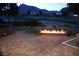 Outdoor seating area with an illuminated fire pit with views of the surrounding golf course at 10612 Back Plains Dr, Las Vegas, NV 89134