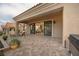 Covered back patio with tiled surface and sliding glass doors offering indoor-outdoor living at 10612 Back Plains Dr, Las Vegas, NV 89134