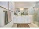 Elegant bathroom with a glass shower, dual sinks, and decorative mirrors and lighting at 10612 Back Plains Dr, Las Vegas, NV 89134