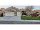 Well-maintained single-story home featuring a three-car garage, neutral palette, and a green lawn at 10612 Back Plains Dr, Las Vegas, NV 89134