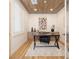 A modern home office featuring light wood floors, a decorative ceiling and minimalist decor at 10612 Back Plains Dr, Las Vegas, NV 89134