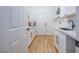 Well-organized laundry room with quartz countertop, basin sink, and bright white cabinets at 10612 Back Plains Dr, Las Vegas, NV 89134