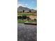 Paver patio with fire feature, lush landscaping, and views of the golf course and mountains at 10612 Back Plains Dr, Las Vegas, NV 89134