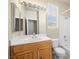 Bathroom with a wood vanity, white countertops, a tub/shower combo, and natural light at 1123 Scenic Crest Dr, Henderson, NV 89052