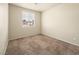 Vacant bedroom features neutral walls, carpet flooring, and bright natural light from a window at 1123 Scenic Crest Dr, Henderson, NV 89052