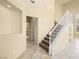 Bright foyer with tile flooring, staircase, neutral walls, and an arched niche for décor at 1123 Scenic Crest Dr, Henderson, NV 89052