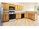 Bright kitchen featuring wood cabinetry, granite countertops, and stainless steel appliances at 1123 Scenic Crest Dr, Henderson, NV 89052