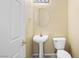 Cozy powder room with a pedestal sink, oval mirror, and modern lighting fixture at 1123 Scenic Crest Dr, Henderson, NV 89052