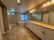 Elegant bathroom featuring double sinks, a soaking tub, and a separate shower at 11260 Burning River St, Las Vegas, NV 89183