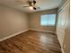 Bedroom with wood-look flooring, a ceiling fan, and a closet at 11260 Burning River St, Las Vegas, NV 89183