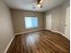 Neutral bedroom with ceiling fan, hardwood floors, and a window with blinds for privacy at 11260 Burning River St, Las Vegas, NV 89183