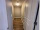 Narrow hallway with wood flooring leads to a closet, providing extra storage space at 11260 Burning River St, Las Vegas, NV 89183