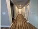 Long hallway with multiple white doors and hardwood floors creates a functional space at 11260 Burning River St, Las Vegas, NV 89183