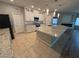 Modern kitchen featuring white cabinets, granite countertops, and a stainless steel microwave at 11260 Burning River St, Las Vegas, NV 89183