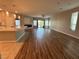 Open-concept living room with wood flooring, a fireplace, and sliding glass doors at 11260 Burning River St, Las Vegas, NV 89183