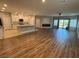 Spacious living room featuring wood floors, a fireplace, and an open layout to the kitchen at 11260 Burning River St, Las Vegas, NV 89183