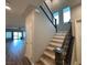 Staircase with wood and white trim, black banister, and natural light from nearby windows at 11260 Burning River St, Las Vegas, NV 89183