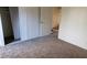 Bedroom with neutral carpet, closet, and an adjacent stairway at 1336 N Jones Blvd, Las Vegas, NV 89108