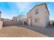 A spacious gravel backyard with a covered patio is perfect for outdoor activities and entertaining at 1338 Ossa St, Henderson, NV 89052