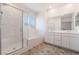 Bathroom featuring a separate glass shower, tub and double sink vanity at 1338 Ossa St, Henderson, NV 89052