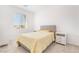 Well-lit bedroom featuring a yellow bed set and two nightstands, complemented by a bright window view at 1338 Ossa St, Henderson, NV 89052