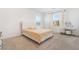 Bright bedroom featuring a tufted headboard and large windows with decorative curtains at 1338 Ossa St, Henderson, NV 89052