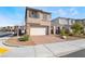 Two-story house with a two-car garage and a brick paver driveway in a desert landscaped yard at 1338 Ossa St, Henderson, NV 89052