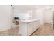 Bright kitchen showcasing an island with a white countertop and ample cabinet space, flowing into the living area at 1338 Ossa St, Henderson, NV 89052