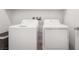 Bright laundry room showcasing a modern, front-loading washer and dryer set at 1338 Ossa St, Henderson, NV 89052