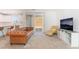 Bright living room featuring modern furniture, a TV, and sliding glass doors to the backyard at 1338 Ossa St, Henderson, NV 89052