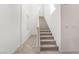 Bright staircase with carpeted steps and light walls leading to an upper floor at 1338 Ossa St, Henderson, NV 89052