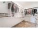 Spacious walk-in closet featuring ample storage and well-organized hanging clothes at 1338 Ossa St, Henderson, NV 89052