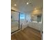 Bathroom featuring double sinks, a walk-in shower, tub, and modern wood-style flooring at 1586 Crowned Eagle St, Las Vegas, NV 89138