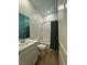 Modern bathroom with shower/tub combination, white vanity, and leafy wallpaper at 1586 Crowned Eagle St, Las Vegas, NV 89138