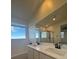 Bright bathroom featuring dual sinks with a large mirror and a large window at 1586 Crowned Eagle St, Las Vegas, NV 89138