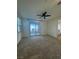 A room with neutral carpet, ceiling fan, access to window and patio at 1586 Crowned Eagle St, Las Vegas, NV 89138