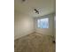 Bedroom featuring neutral carpet, a window for natural light, and easy access to other areas of the home at 1586 Crowned Eagle St, Las Vegas, NV 89138