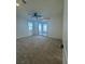 A room with neutral carpet, ceiling fan, access to window and patio at 1586 Crowned Eagle St, Las Vegas, NV 89138