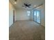 Spacious bedroom featuring carpet floors, a window and access to a balcony at 1586 Crowned Eagle St, Las Vegas, NV 89138