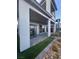 Back exterior featuring a stone patio, green grass, and modern architectural design at 1586 Crowned Eagle St, Las Vegas, NV 89138