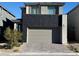 Modern two-story home featuring a two-car garage and brick paved driveway at 1586 Crowned Eagle St, Las Vegas, NV 89138