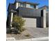 Modern two-story home featuring a two-car garage and brick paved driveway at 1586 Crowned Eagle St, Las Vegas, NV 89138