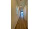 Hallway with hardwood floors leading to a living area and a window with blinds at 1586 Crowned Eagle St, Las Vegas, NV 89138