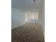 Upstairs hallway featuring neutral carpet and access to various rooms and window at 1586 Crowned Eagle St, Las Vegas, NV 89138