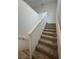 Carpeted staircase with white walls and railing leading to the second floor at 1586 Crowned Eagle St, Las Vegas, NV 89138