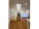 View of staircase with carpeted steps and a white railing and front door, leading to a wooden floor at 1586 Crowned Eagle St, Las Vegas, NV 89138