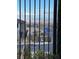 A view through fencing of city buildings and a clear sky for a scenic experience at 1586 Crowned Eagle St, Las Vegas, NV 89138