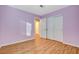 Bedroom featuring wood floors, a closet with sliding doors, and a fresh coat of purple paint at 1800 Summit Pointe Dr, Las Vegas, NV 89117