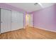 This bedroom features wood floors, a closet with sliding doors, and a fresh coat of purple paint at 1800 Summit Pointe Dr, Las Vegas, NV 89117